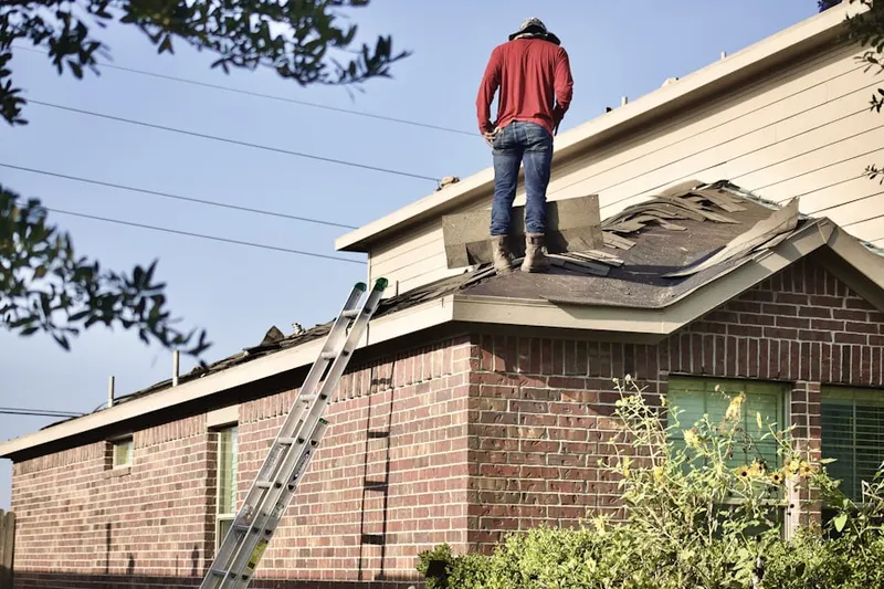 Professional roofer working on a residential roof in Weston